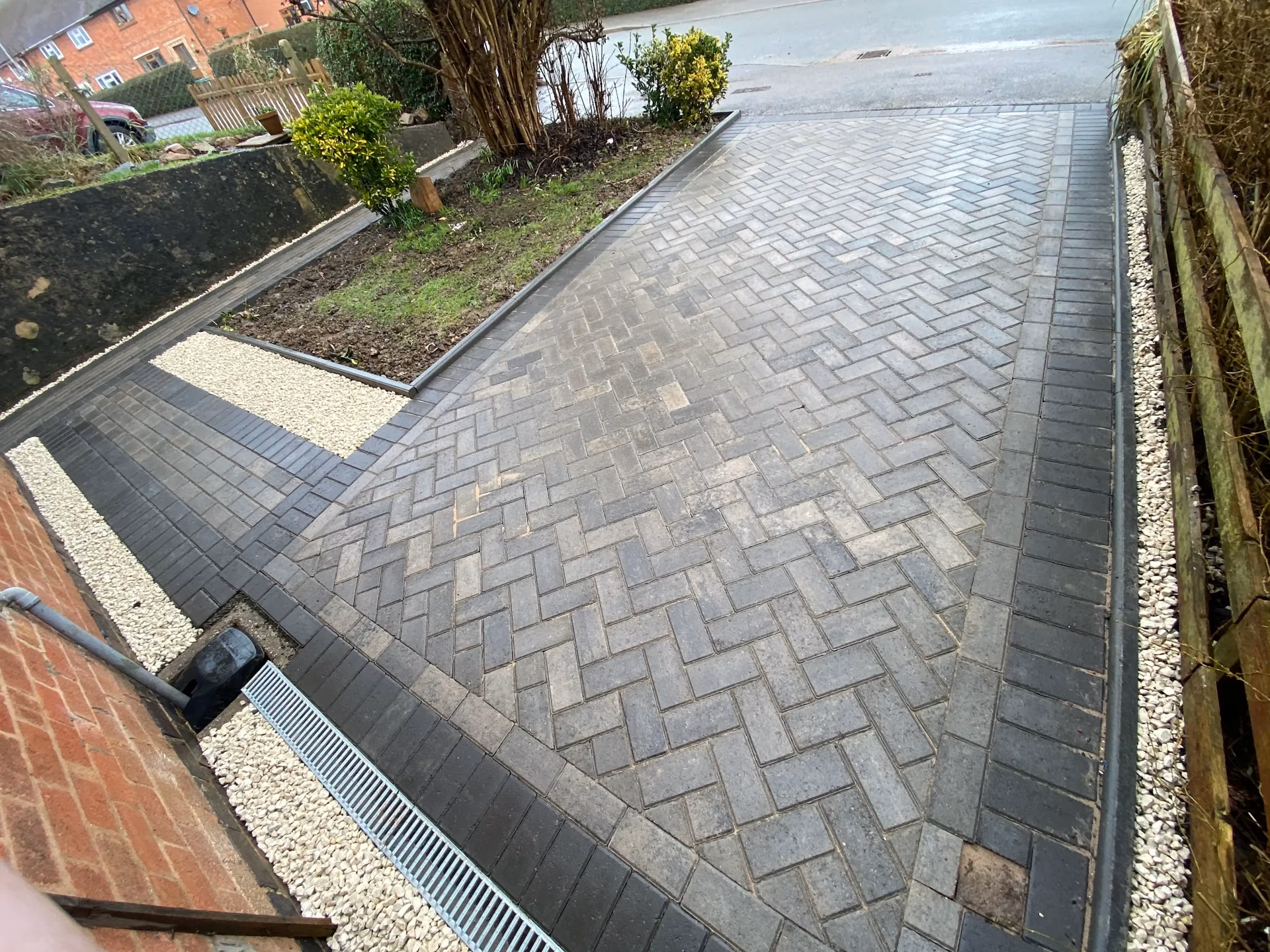 Close detail of grey block paving with a charcoal border
