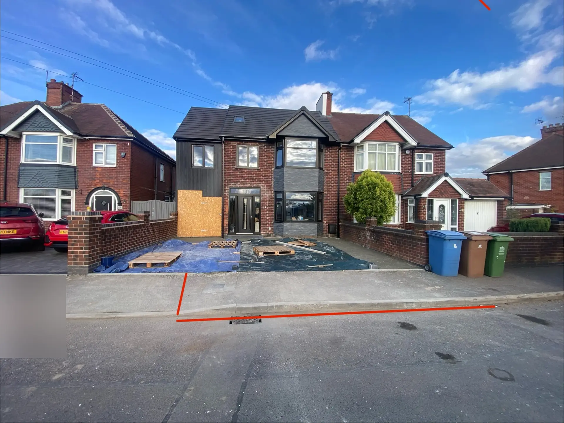 New stone base laid on a Mansfield front garden with the kerb crossing line marked out in red on the road