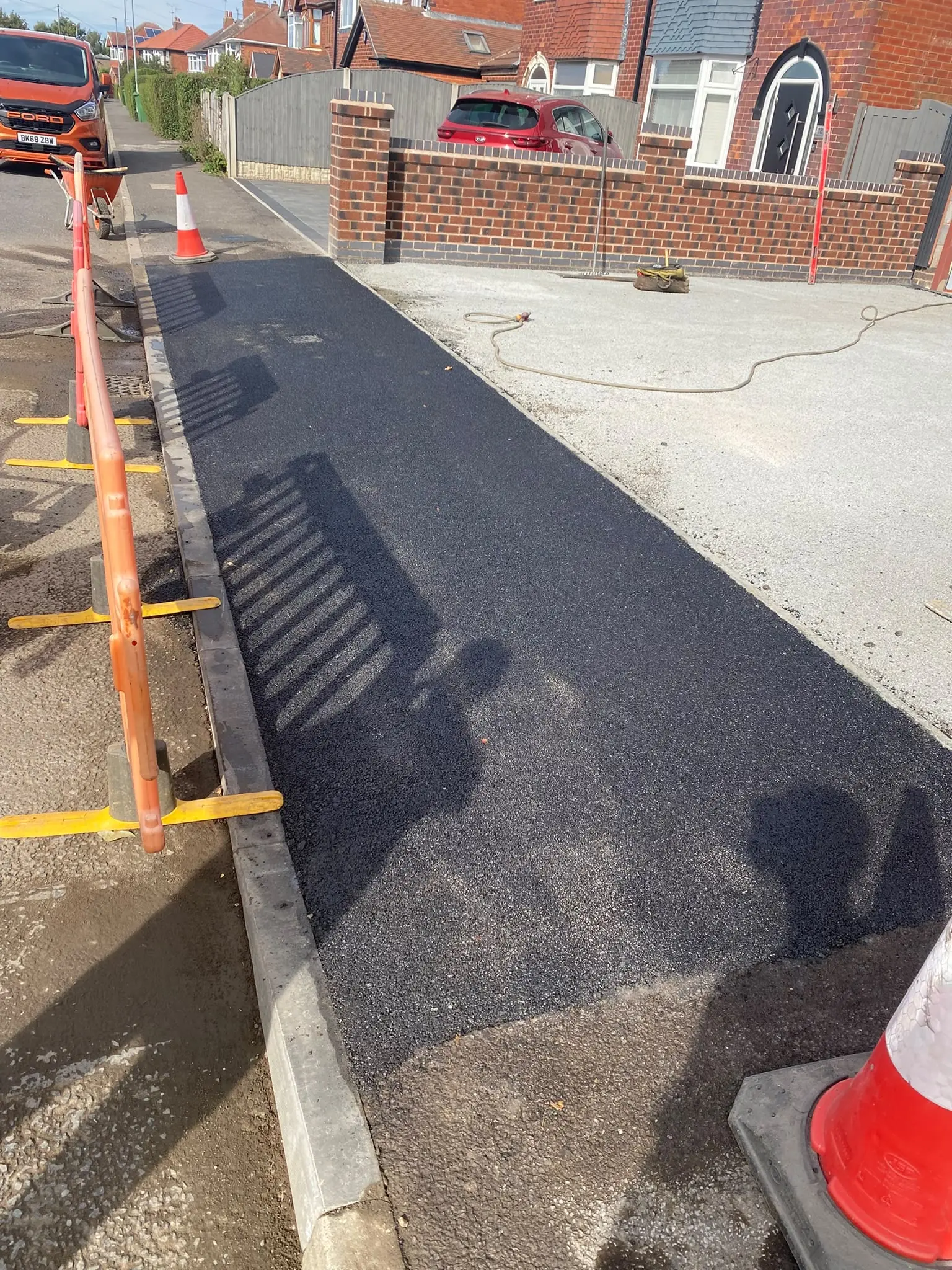Freshly laid tarmac crossing over the pavement for a new dropped kerb in Mansfield