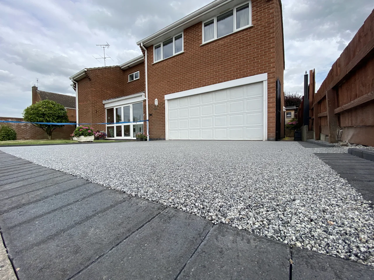 Light aggregate driveway with charcoal block edging