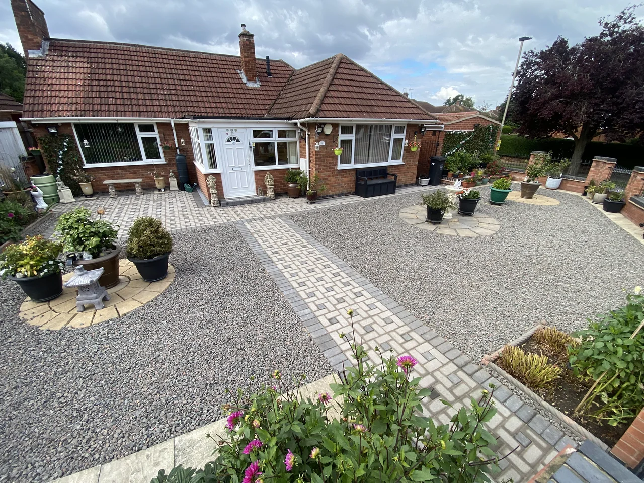 Gravel front garden with a block-paved path
