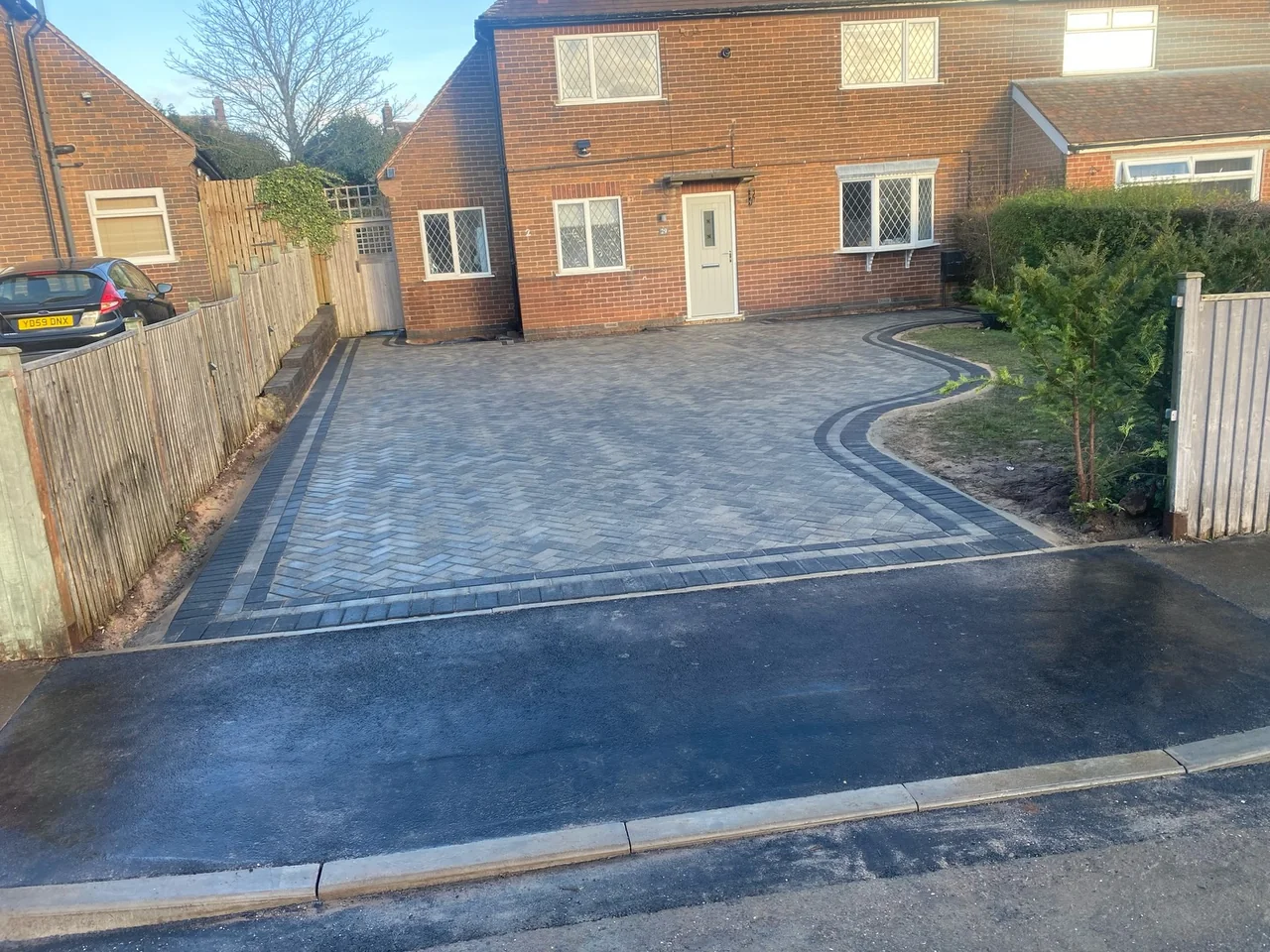New block-paved driveway with a dropped kerb at the road edge