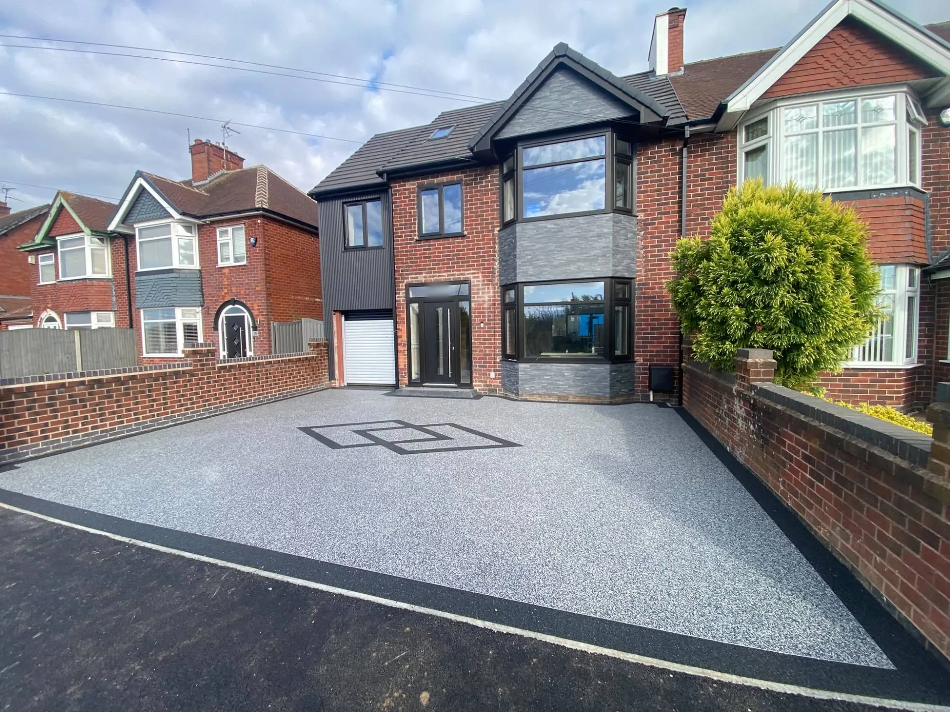 Resin bound driveway seen from the road, with the new dropped kerb crossing and black border in Mansfield