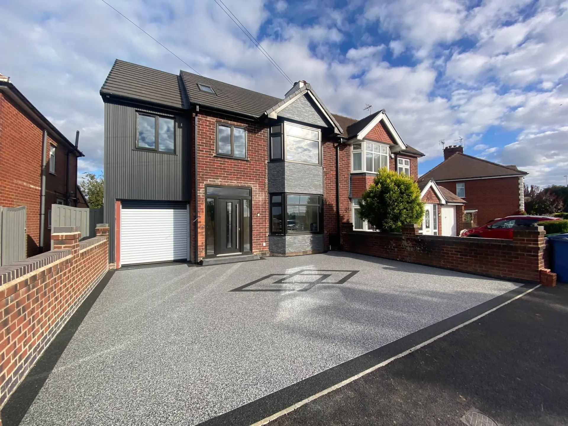 Finished grey resin bound driveway with an inlaid diamond pattern outside an extended semi-detached house in Mansfield