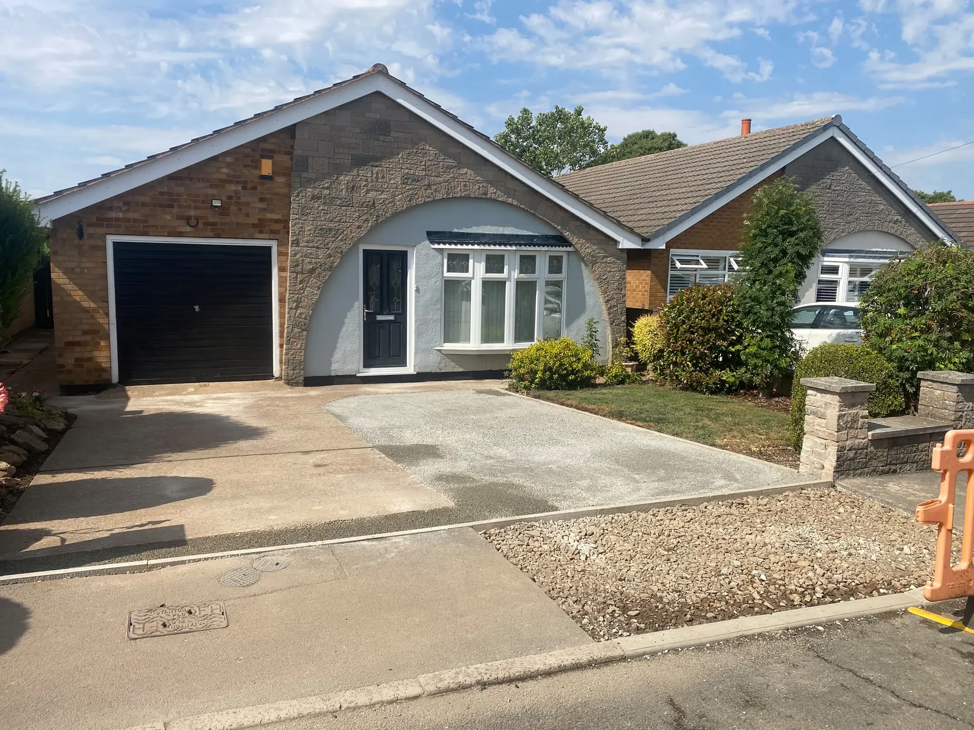 Skegby bungalow front with the old concrete drive and new stone sub-base being laid