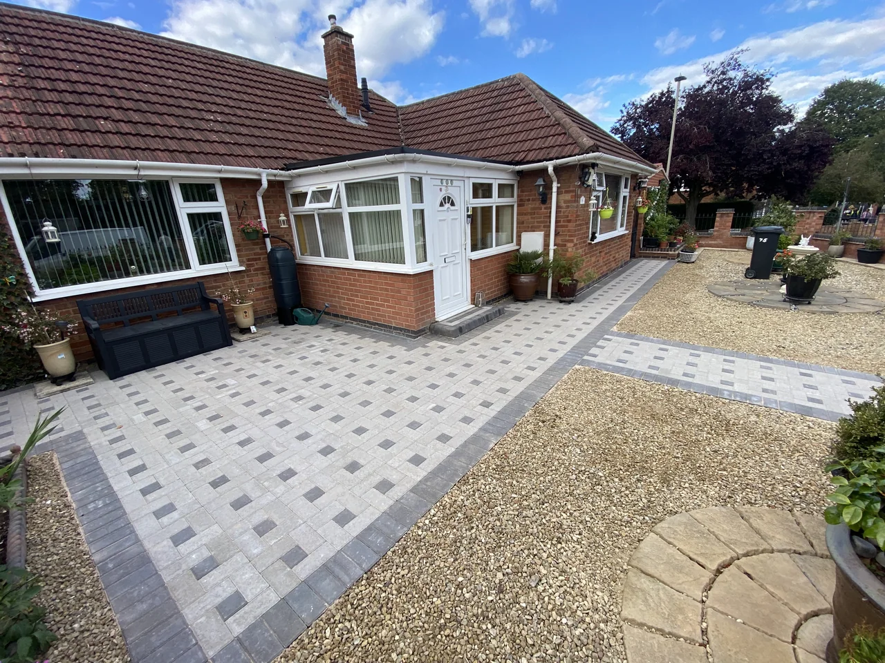 Silver-grey block paving with a feature path
