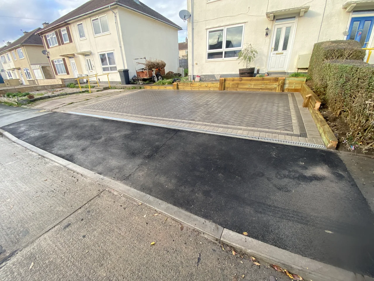 Wide tarmac driveway finished with a block edge